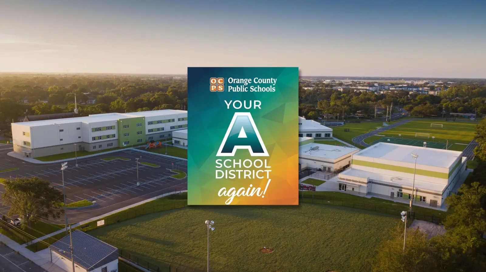 Aerial view of the Audubon Park K-8 campus with an OCPS A school district badge