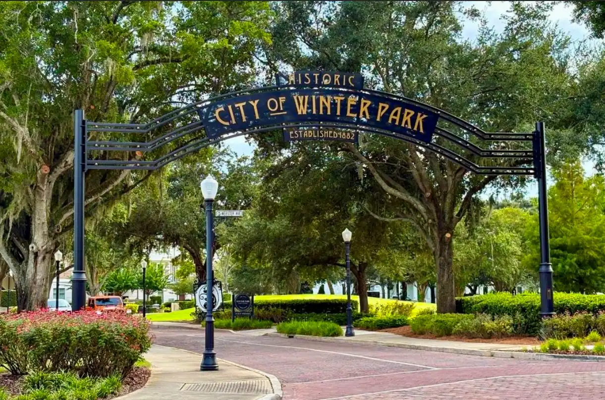 The historic City of Winter Park arch over a brick street
